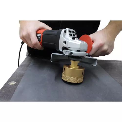 Flex angle grinder with diamond drill bit in use